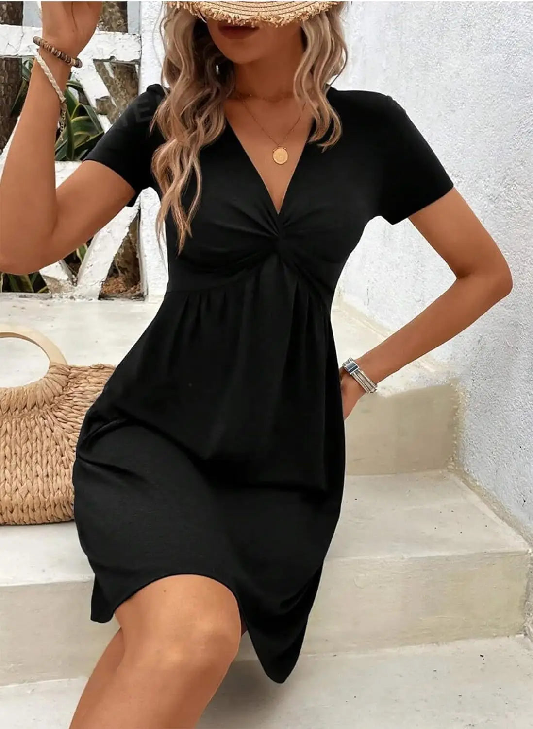 Black short-sleeved v-neck midi dress with a twist front, gathered waist, and asymmetrical hem designed for elegant occasions