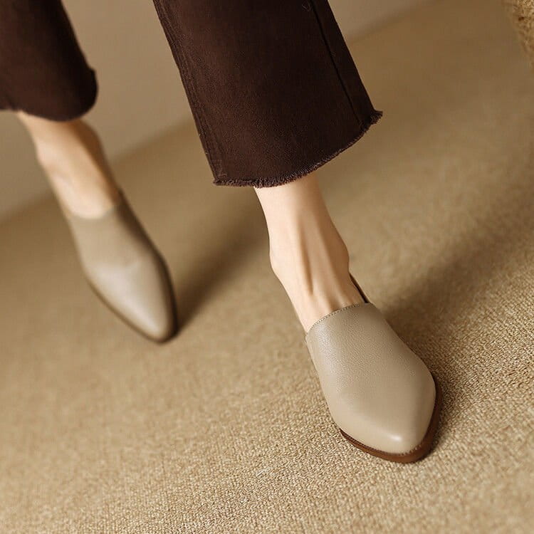 Beige leather mules with a sleek pointed toe and low-profile sole complement women’s leather block heel loafers square toe shoes.