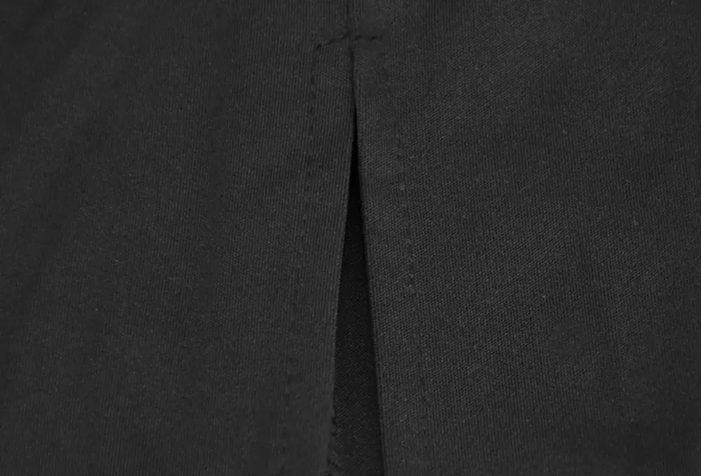 A close-up of a dark gray velvet v-neck evening dress fabric with textured material and visible stitching along the seam.