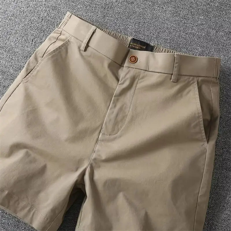 Men casual slim fit cargo shorts in beige chino fabric with button closure and elastic waistband.