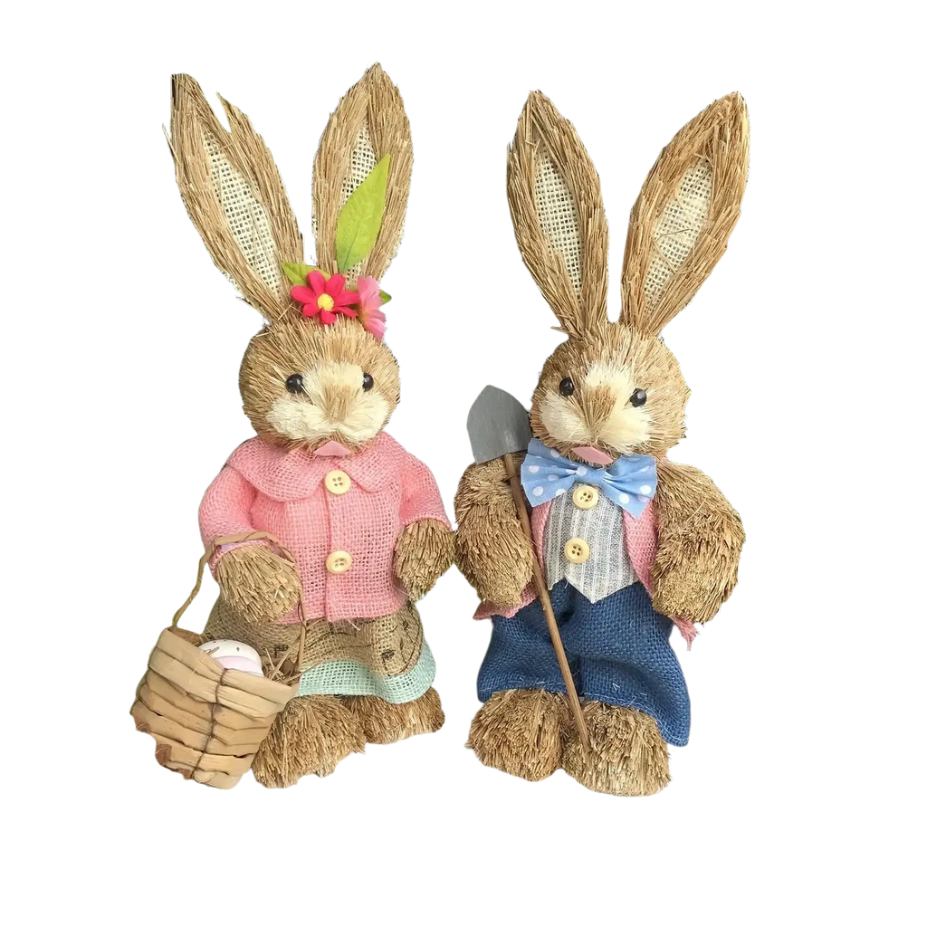 Two 35cm straw easter rabbit figurines set with one in pink jacket holding egg basket and the other in blue overalls holding shovel