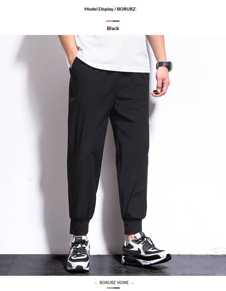 Pantalon de jogging athlétique pour hommes grande taille en coton noir, avec jambes fuselées et poignets élastiques, pour des vêtements de sport confortables.