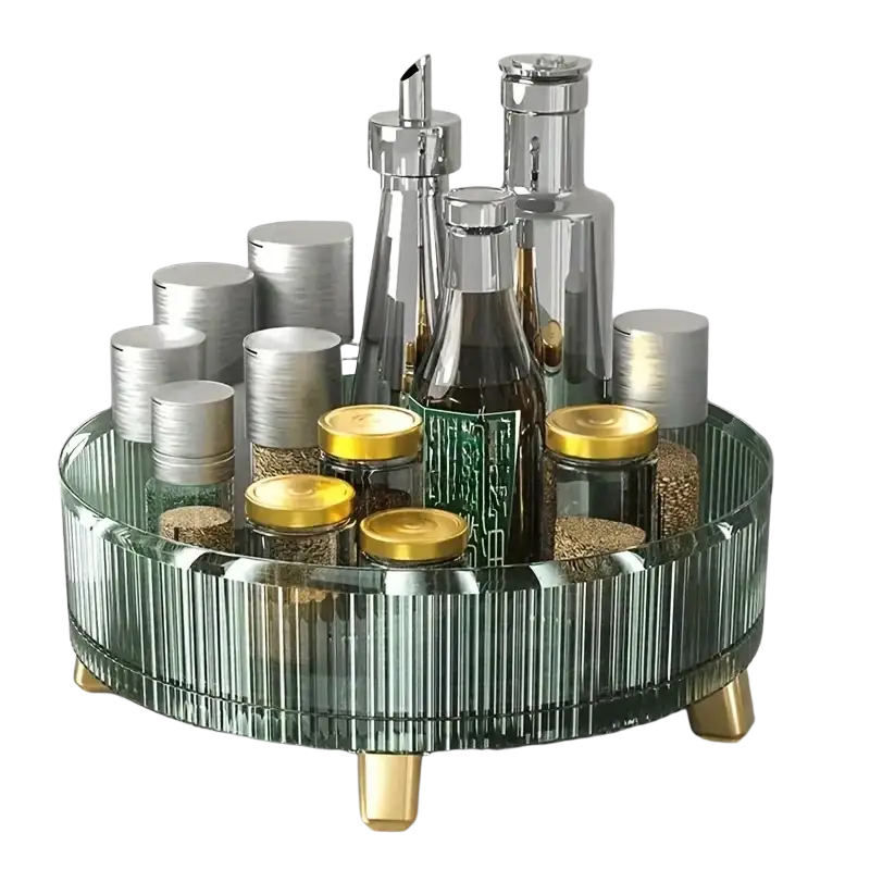 A sleek green ribbed glass 360 rotating makeup organizer with gold-tone legs holds metallic and amber-lidded jars
