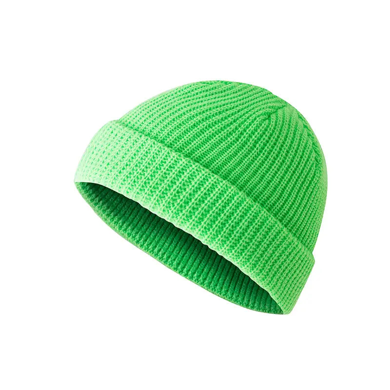 Bright neon green ribbed knit beanie with a folded cuff shown alongside a dark gray ribbed wool beanie hat.