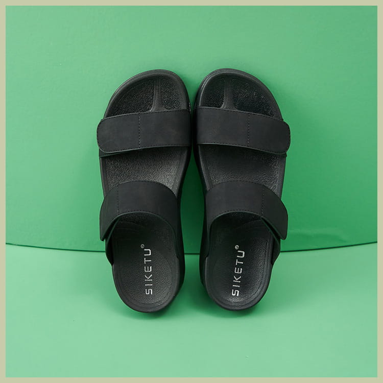 Black siketu slide sandals for women with two adjustable velcro strap bands and a textured rubber sole ideal for sporty platform wear.