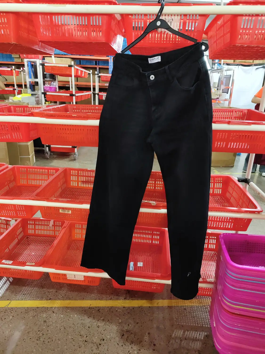 Black denim wide leg stretch jeans with a classic five-pocket design and button closure.