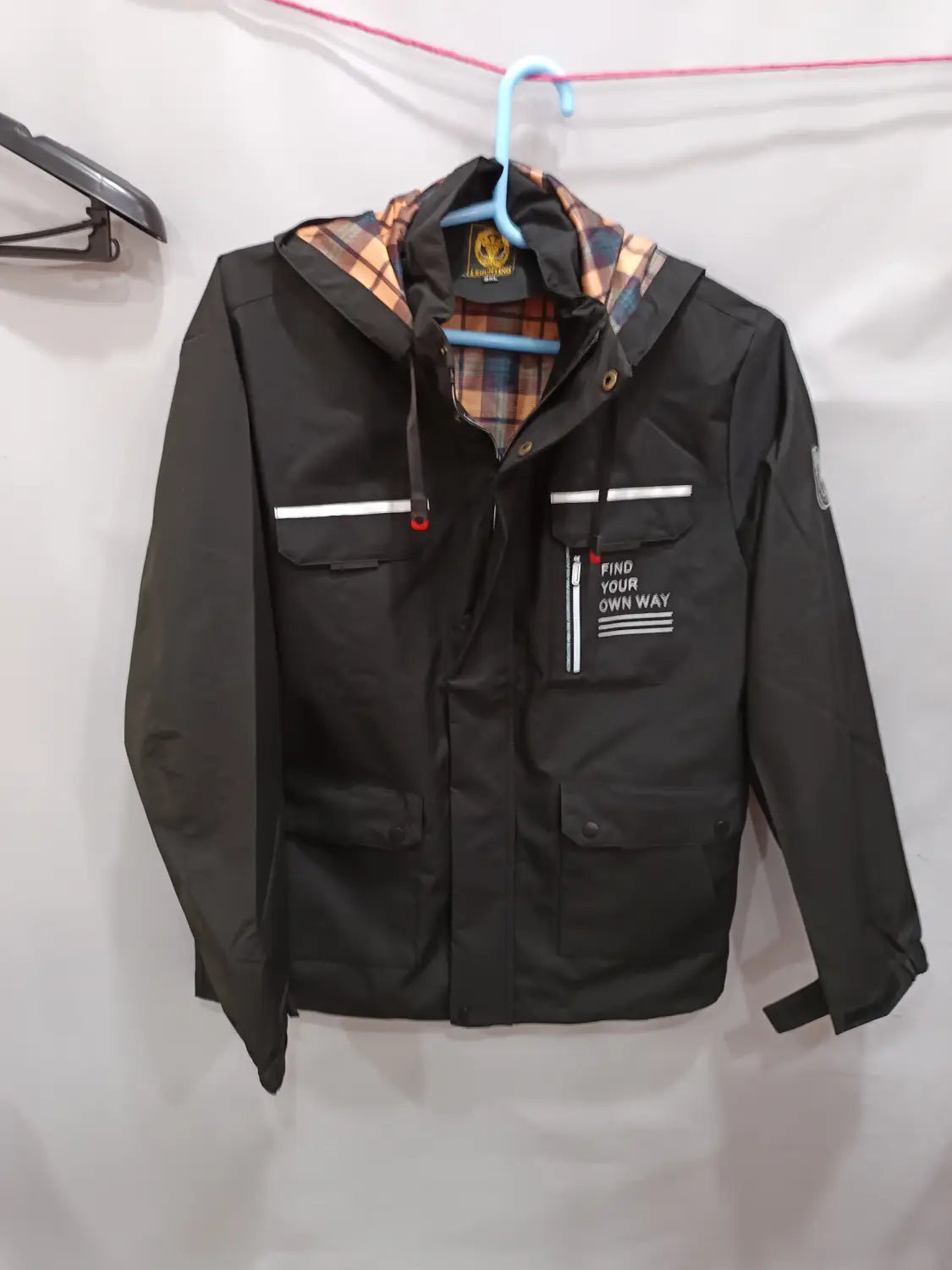 Men winter hooded parka coat in black with plaid lining and white horizontal stripes on the chest featuring a find your own way patch.