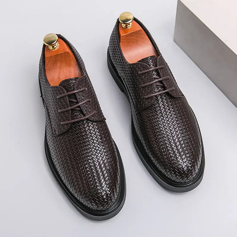 Men’s woven leather platform British dress shoe in black with lace-up design and solid rubber sole.