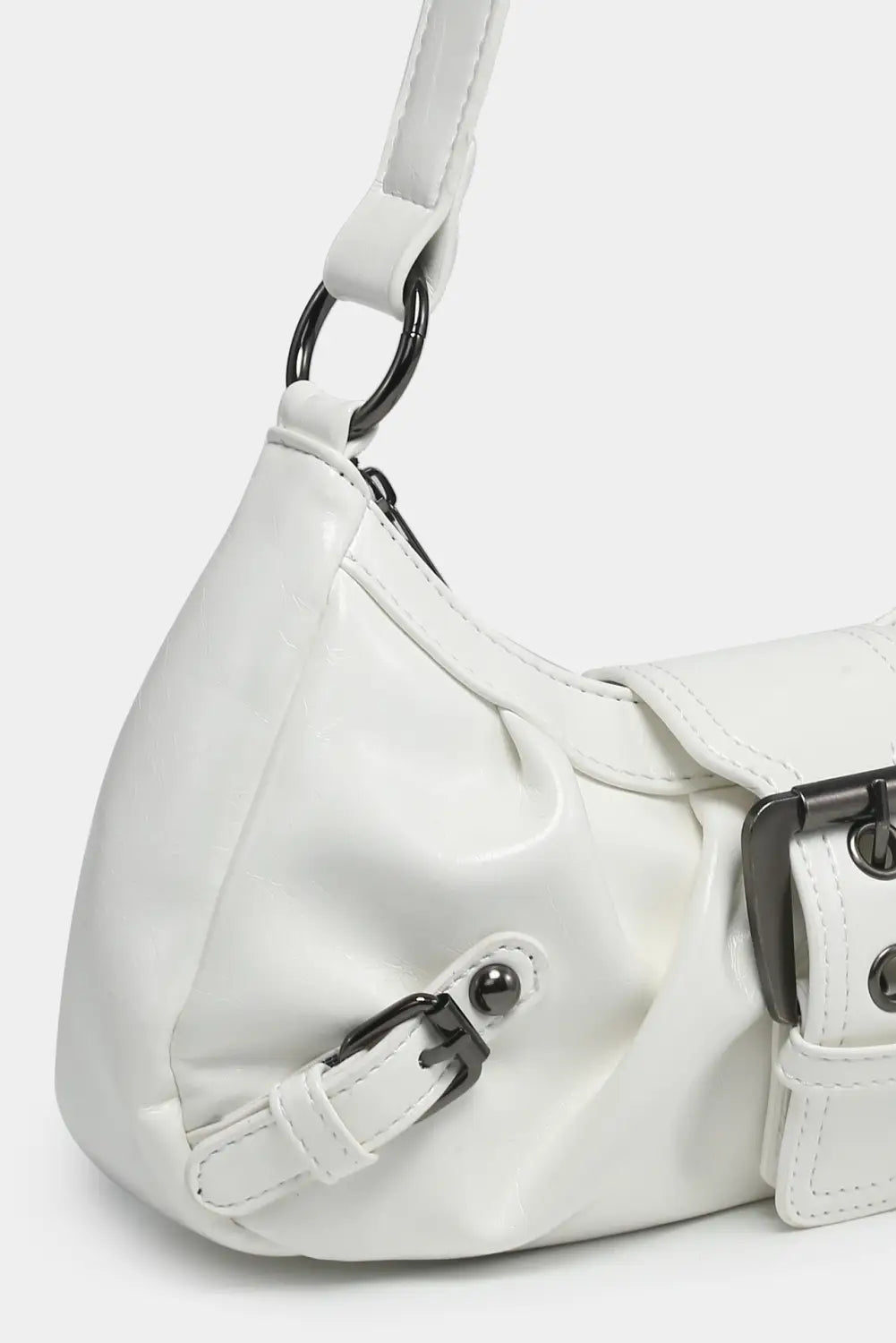 Vintage leather shoulder bag in white faux leather with black metal buckle details for stylish everyday use.
