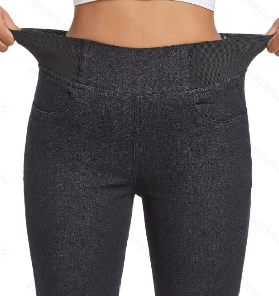 Dark gray fleece lined slim fit denim leggings with an elastic waistband and front pockets designed for maternity wear.
