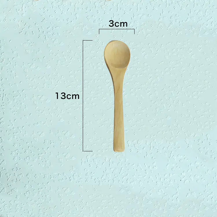 A light-colored wooden spoon with a smooth natural finish and rounded bowl from a wooden spoon set natural eco-friendly kitchen utensils.