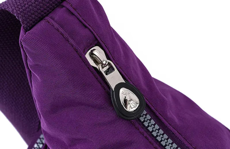 Purple waterproof multi pocket nylon crossbody shoulder bag with a silver zipper, black pull tab, and embossed logo.