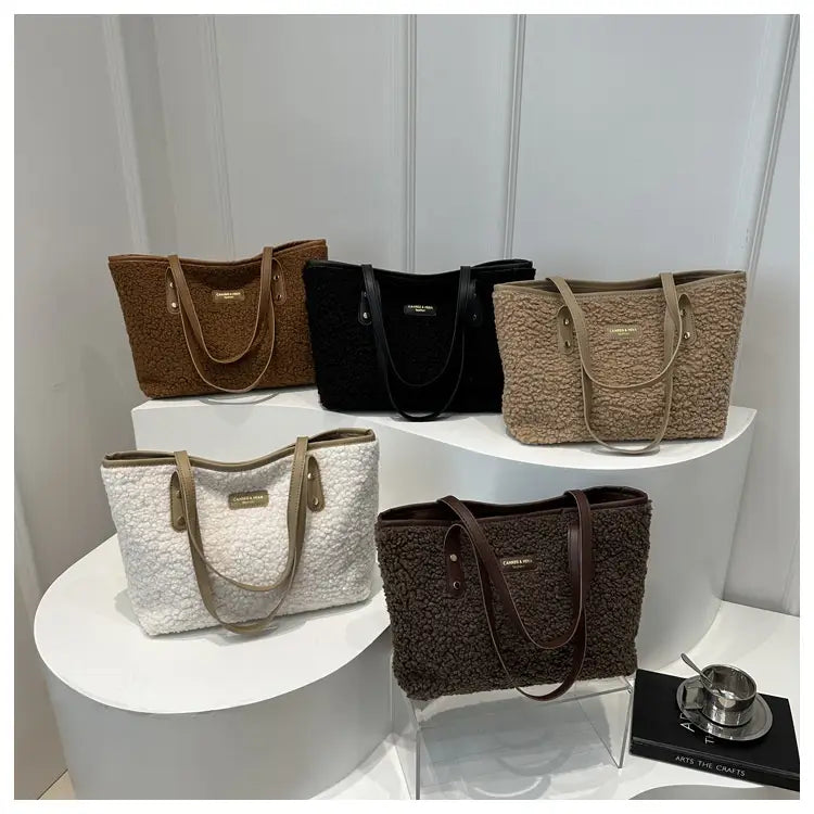 Brown faux fur tote bag with beige fluffy texture contrasting leather handles and a small gold tone brand plaque.