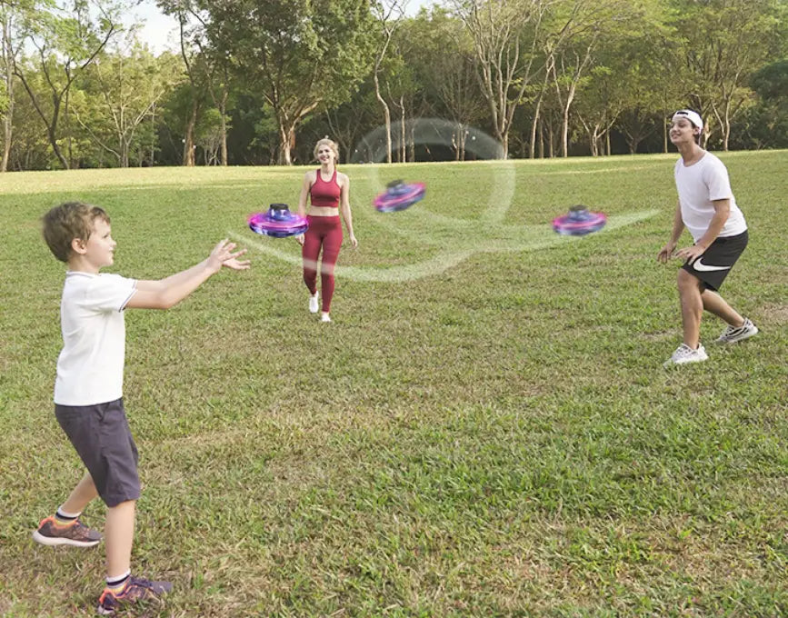 purple and black flying ufo spinner led mini drone fingertip gyro toys captured in mid-air.