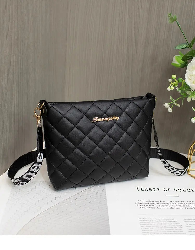 Black quilted chain messenger bag with a gold-tone sunnygoby logo and a striped crossbody strap.