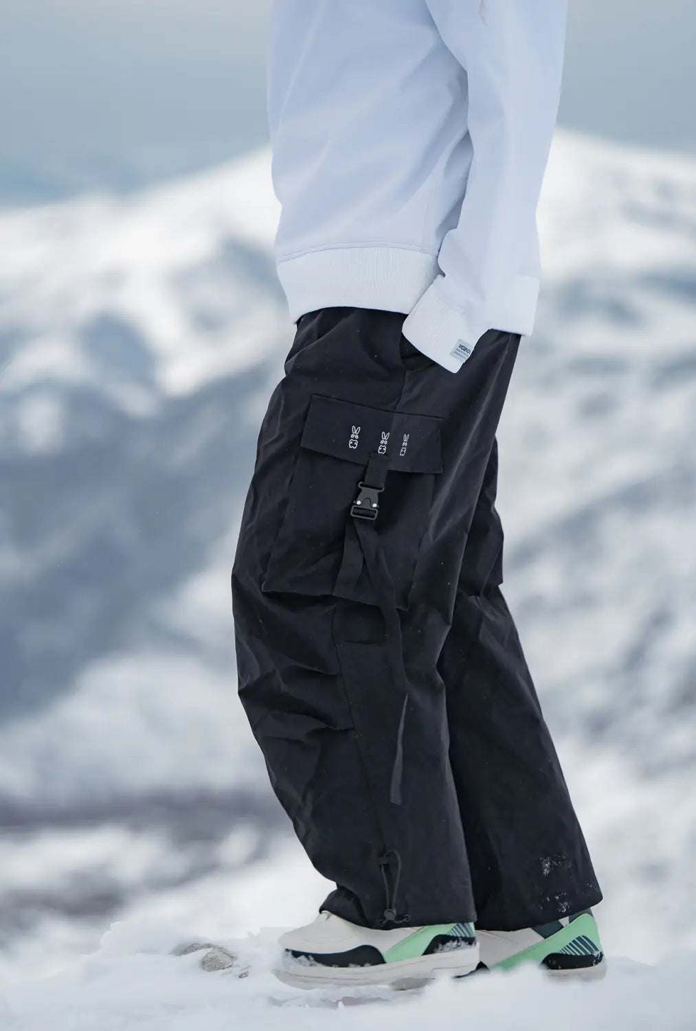black winter outdoor loose ski pants with a sleek modern design and multiple cargo pockets suitable for cold weather activities