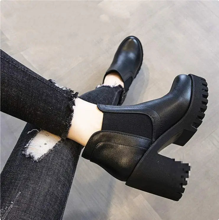 black leather ankle boots for women featuring chunky textured heels and elastic side panels