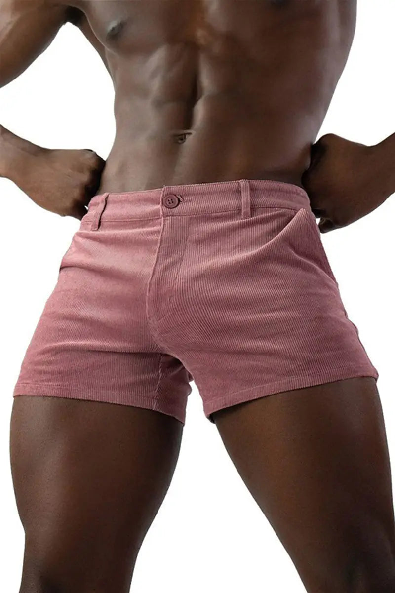 Men corduroy beach shorts in pink with a button closure and belt loops designed for casual mid rise wear.