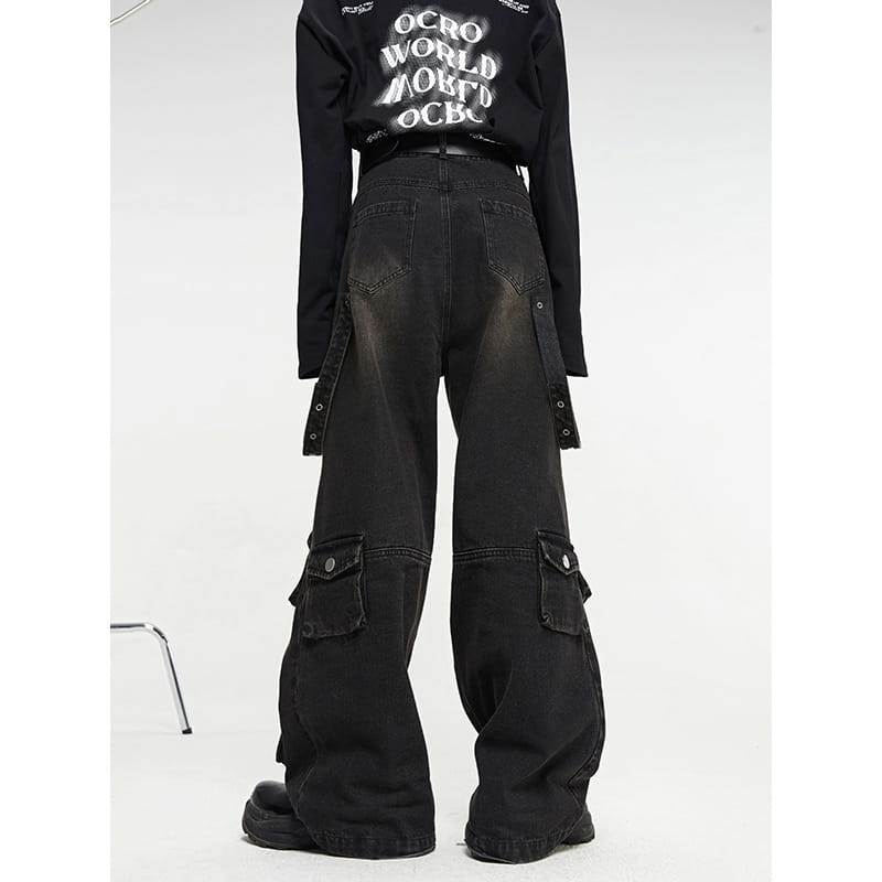 Men’s black distressed wide leg cargo jeans in durable fabric featuring multiple pockets and side straps.