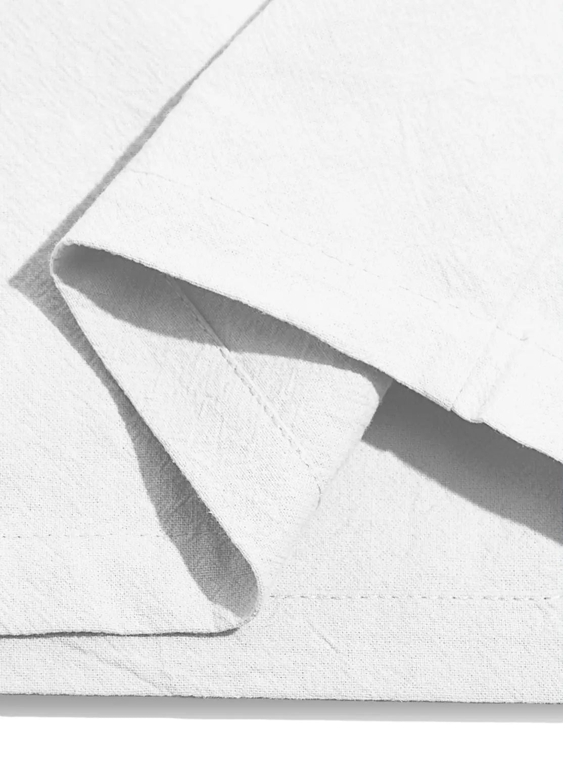 White cotton fabric with visible stitching and soft folds used in mens cotton linen drawstring shorts.