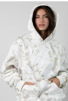 White oversized leafy camouflage lantern sleeve hoodie in cotton with a subtle all over floral pattern in light gray and beige tones.
