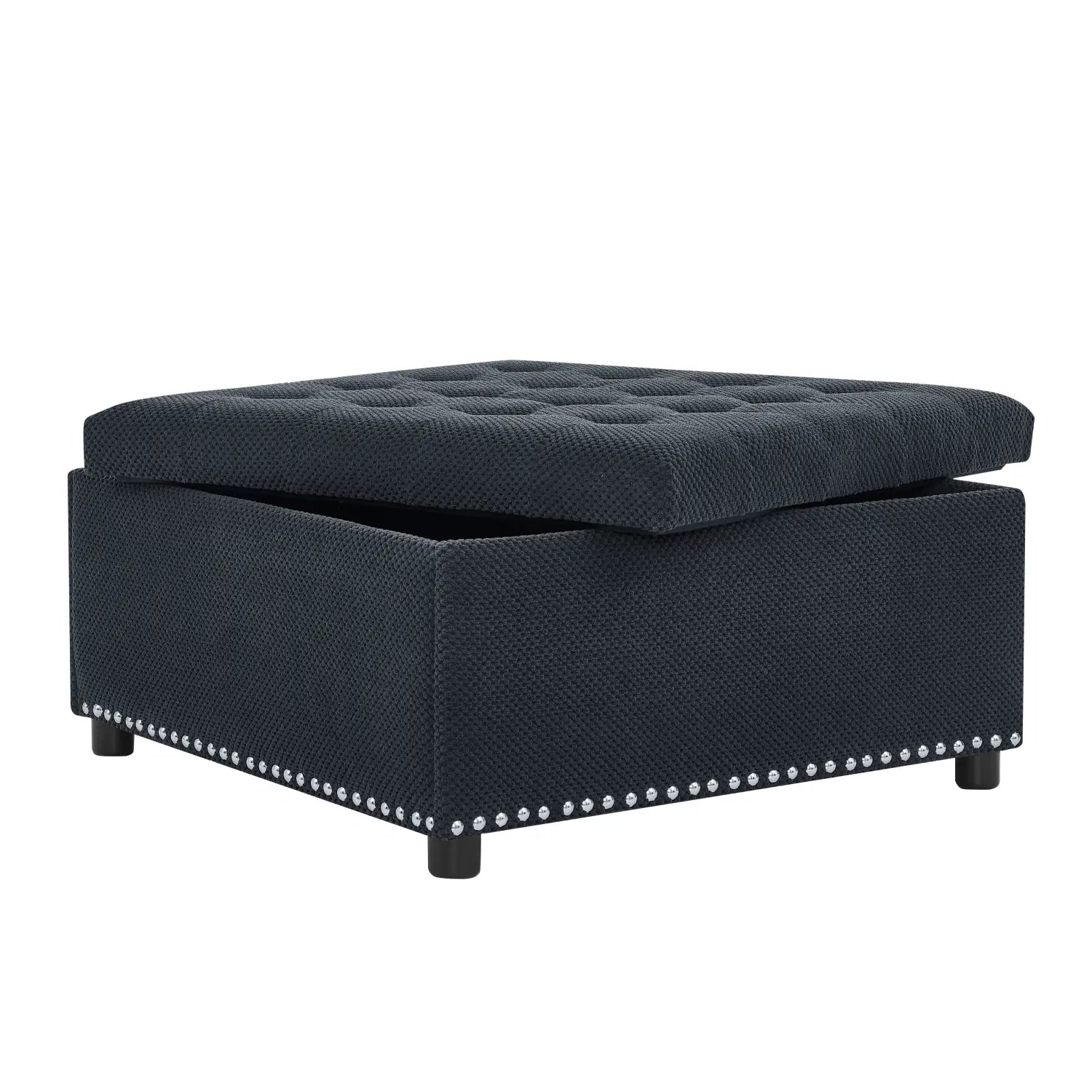 black tufted storage ottoman with dark navy textured fabric finish and decorative silver nailhead trim along the base