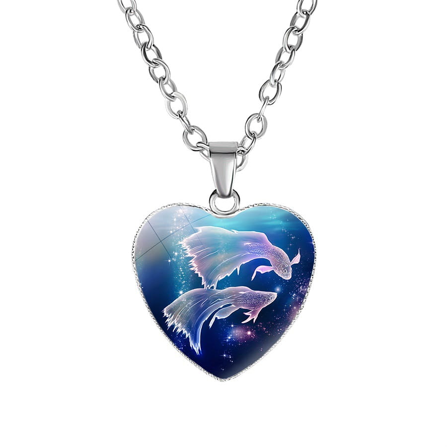 Heart-shaped celestial pendant necklace with a silver chain featuring an illustrated design of two fish against a cosmic blue and purple galaxy background.