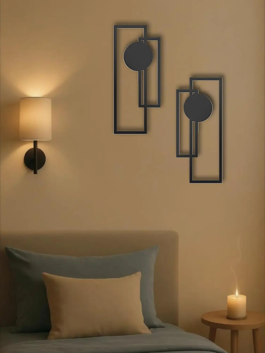 Black metal wall art featuring geometric rectangular frames with circular cutouts in a two piece abstract geometric metal wall art set.