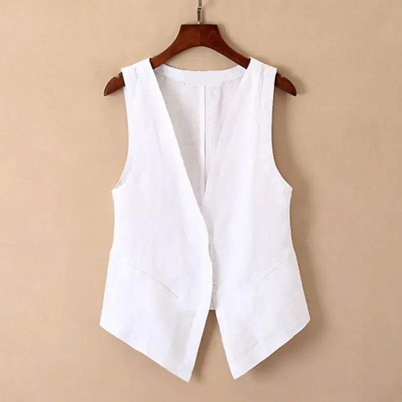 White linen sleeveless vest with v neckline and front pockets hanging on a wooden hanger for casual women wear.