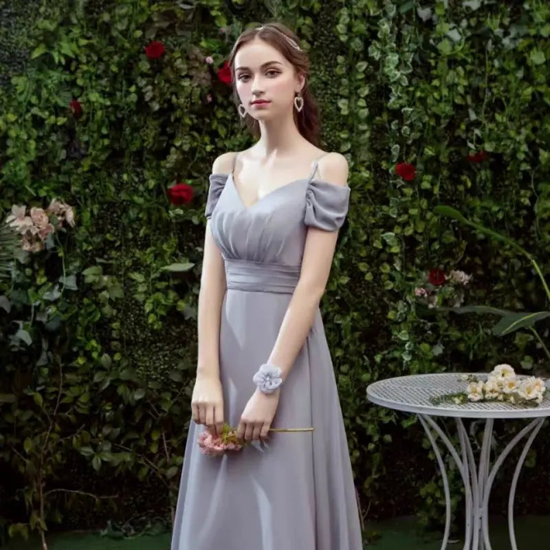 A flowing lavender satin off-the-shoulder gown with puffed sleeves and a fitted waist featured as an off-the-shoulder gray chiffon floor length bridesmaid gown.