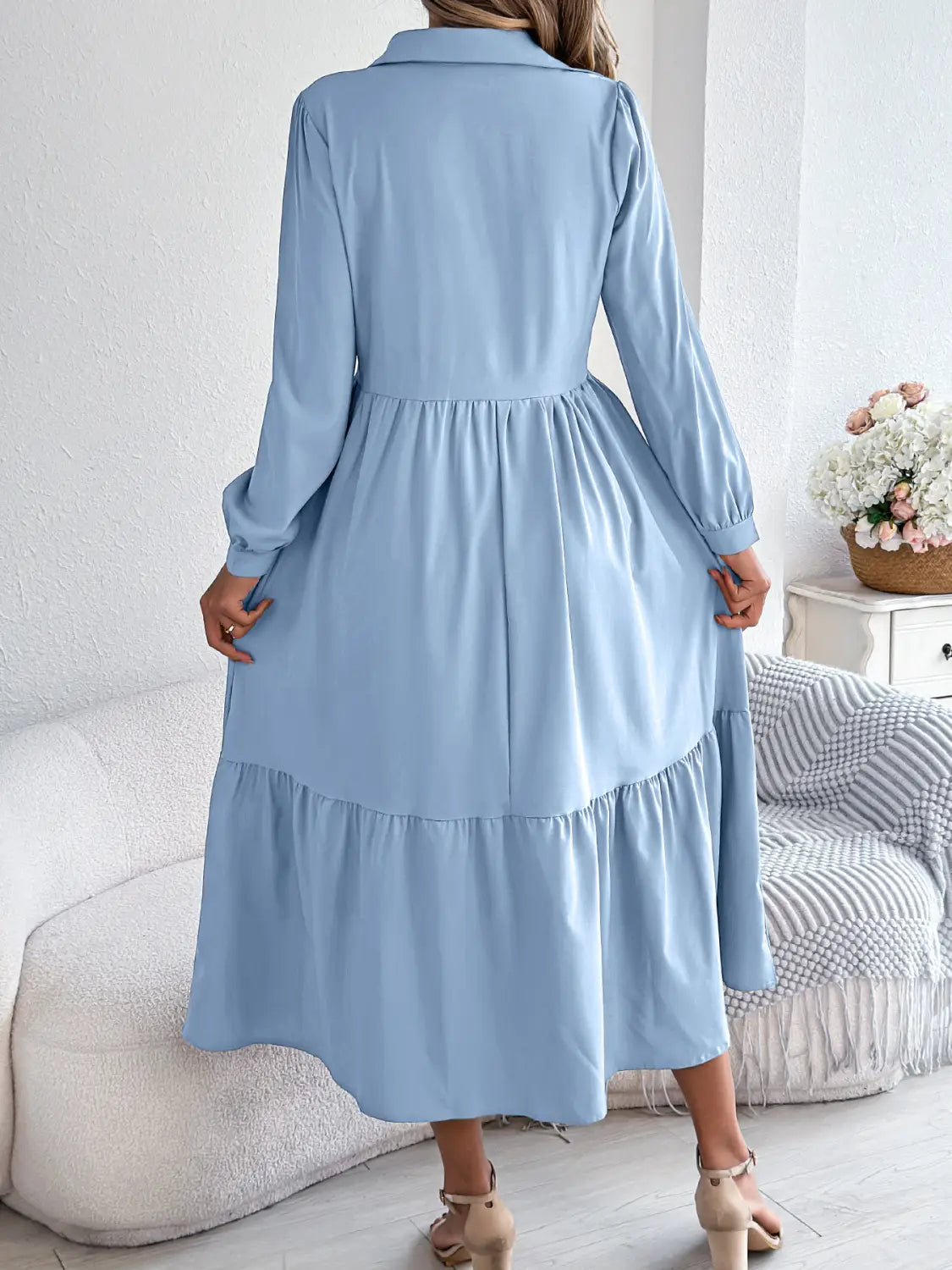 A light blue long sleeve tiered button down midi dress with a collar and gathered waist for women.