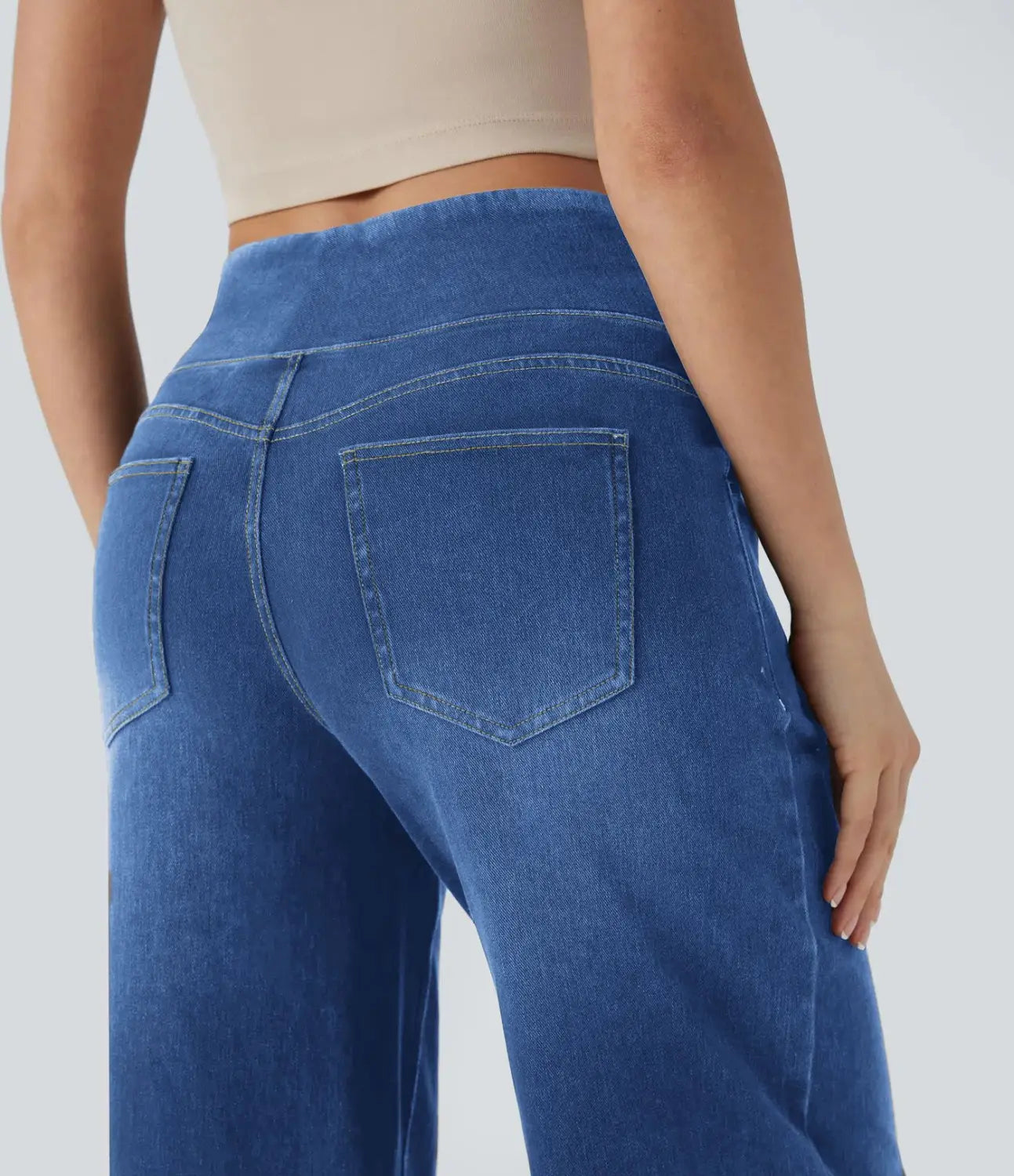 blue denim wide leg stretchy high waisted jeans shown from the back with a relaxed fit and classic back pockets