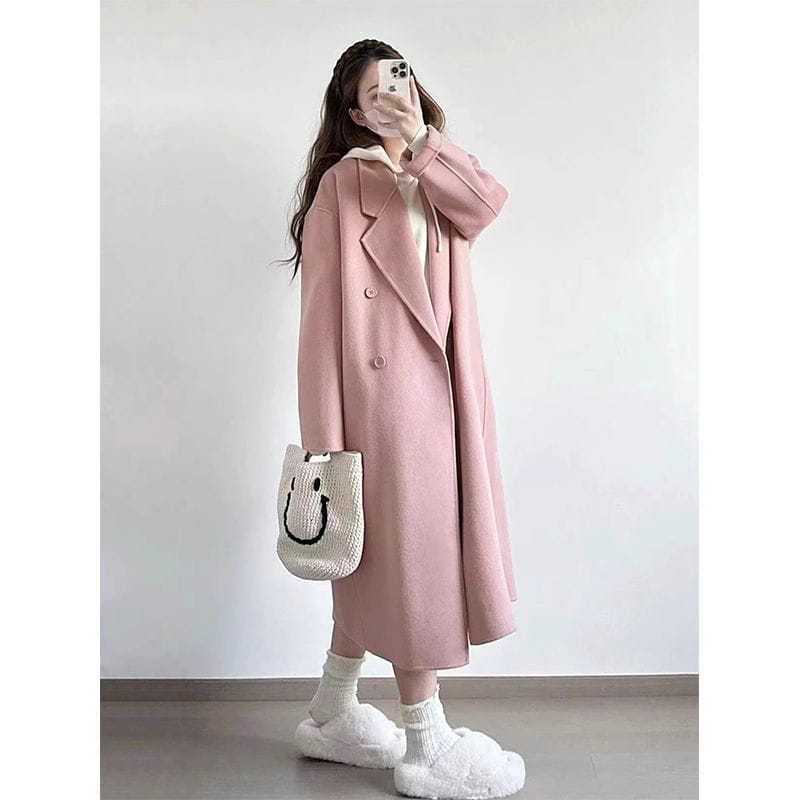 A soft pink longline wool trench coat petite featuring a classic double-breasted design and notched lapels.