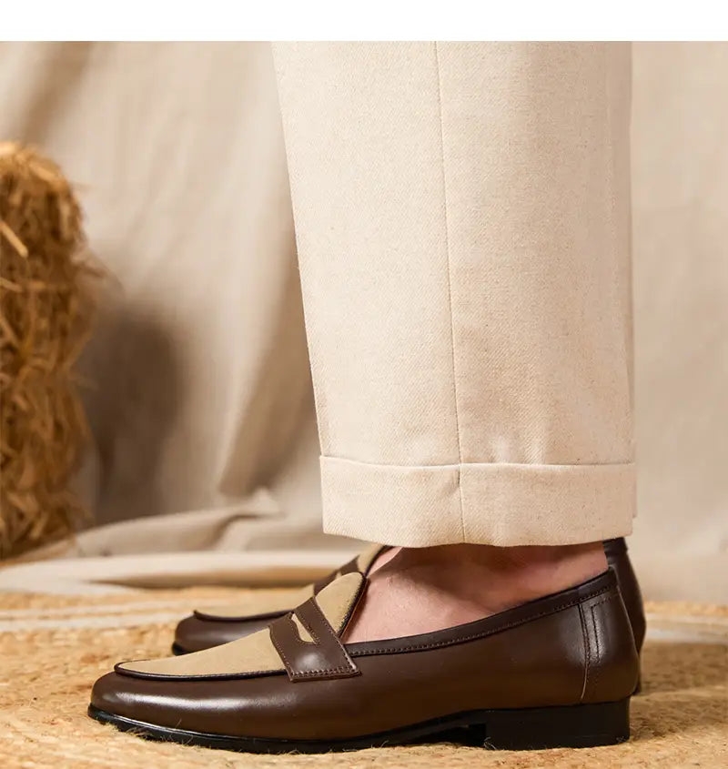 Brown and beige two-tone leather loafers with a classic moccasin-style design and block heel in British style.