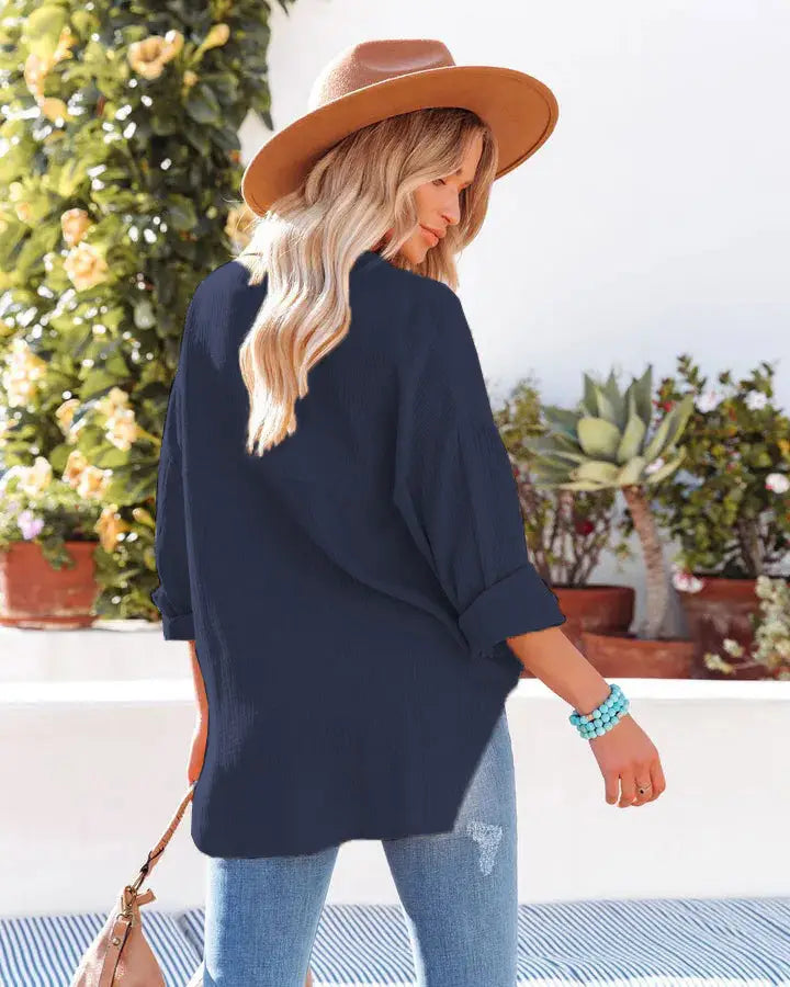 Navy blue oversized blouse with rolled sleeves and a relaxed fit in women’s relaxed fit dropped shoulder button up shirt.