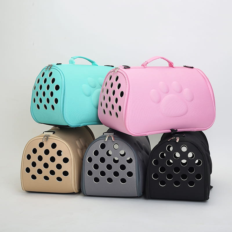 Eva folding pet carrier bag in pink with paw prints features circular ventilation holes and a soft padded exterior for comfortable pet transport.