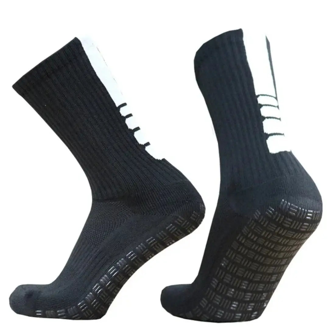 Black grip soccer socks with white side stripes and textured non slip soles designed for athletic use.