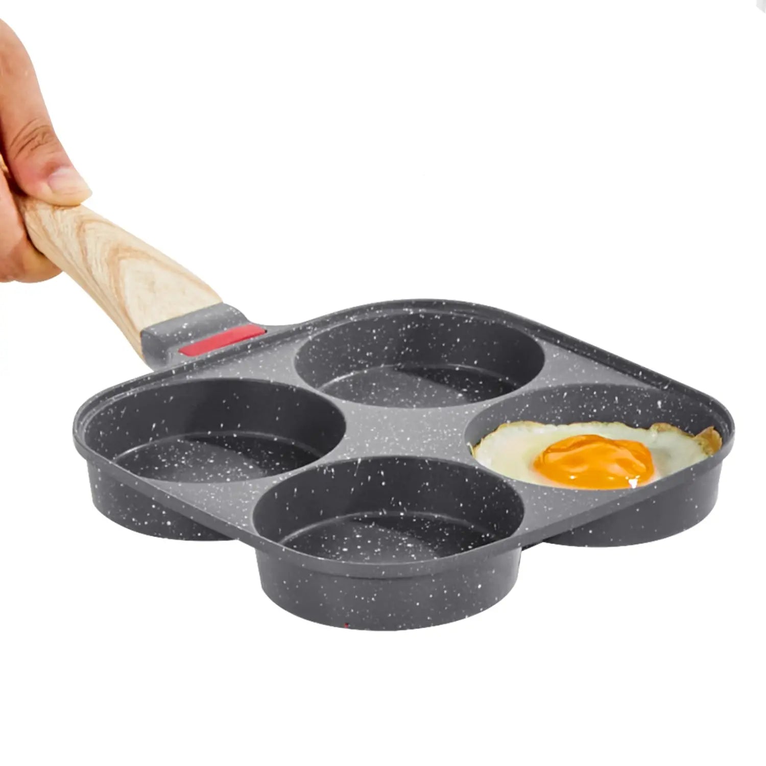 Black speckled 4-cup nonstick egg pan with wooden handle and induction base designed for cooking four eggs.