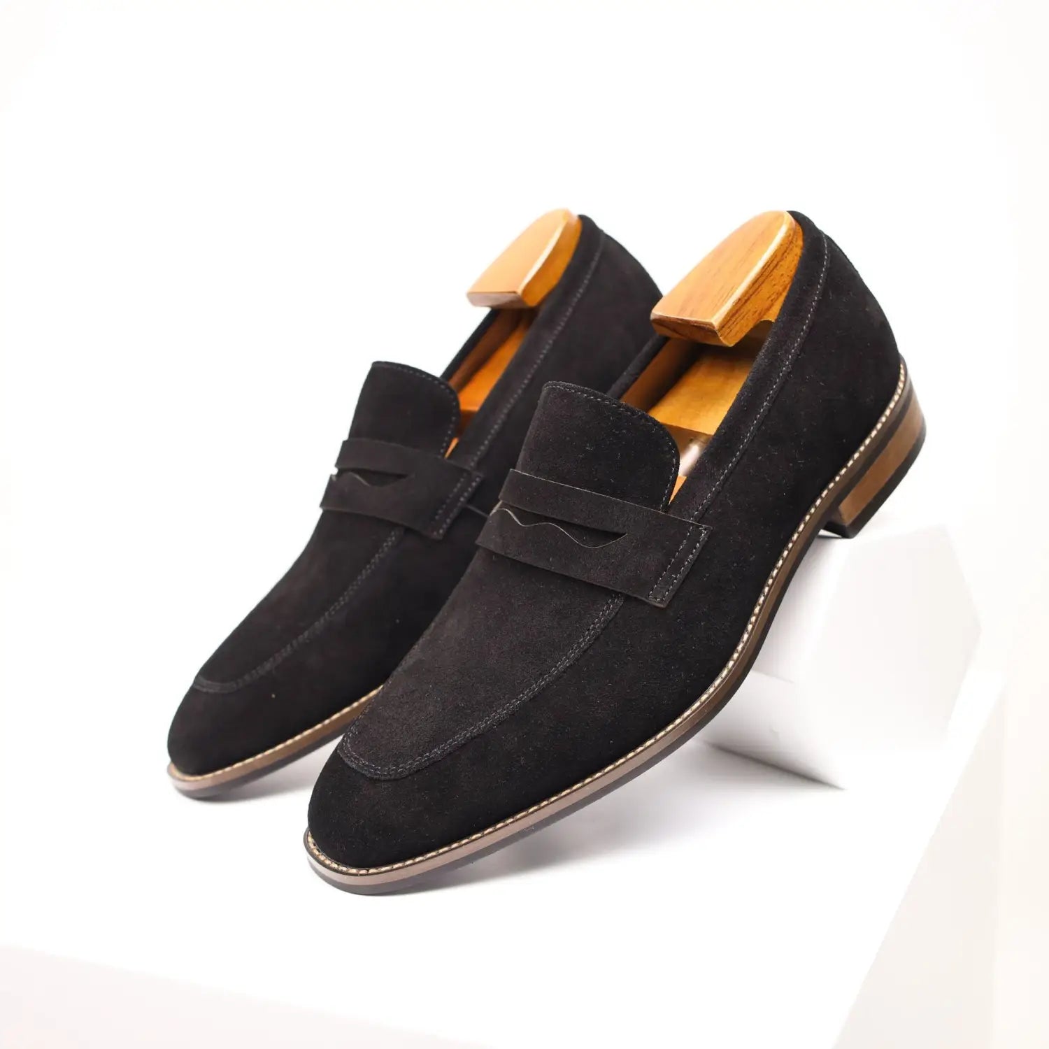 black suede loafers with a classic slip-on design and contrasting tan stitching along the edges for men’s casual leather shoes