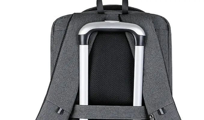 Gray textured business laptop backpack made of oxford cloth with a silver and black handle attachment and a USB charging port.