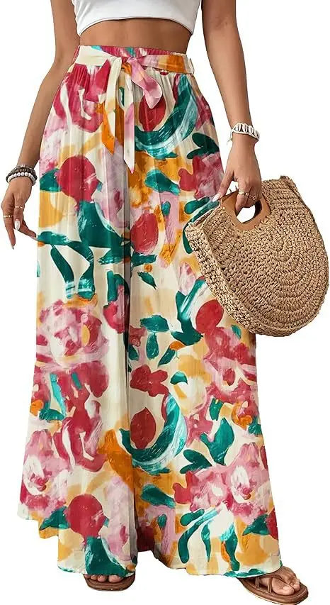 Pantalon évasé à imprimé floral pour femmes, présentant un imprimé floral éclatant rouge, vert et jaune sur un fond de tissu couleur crème, idéal pour une tenue décontractée ou estivale.