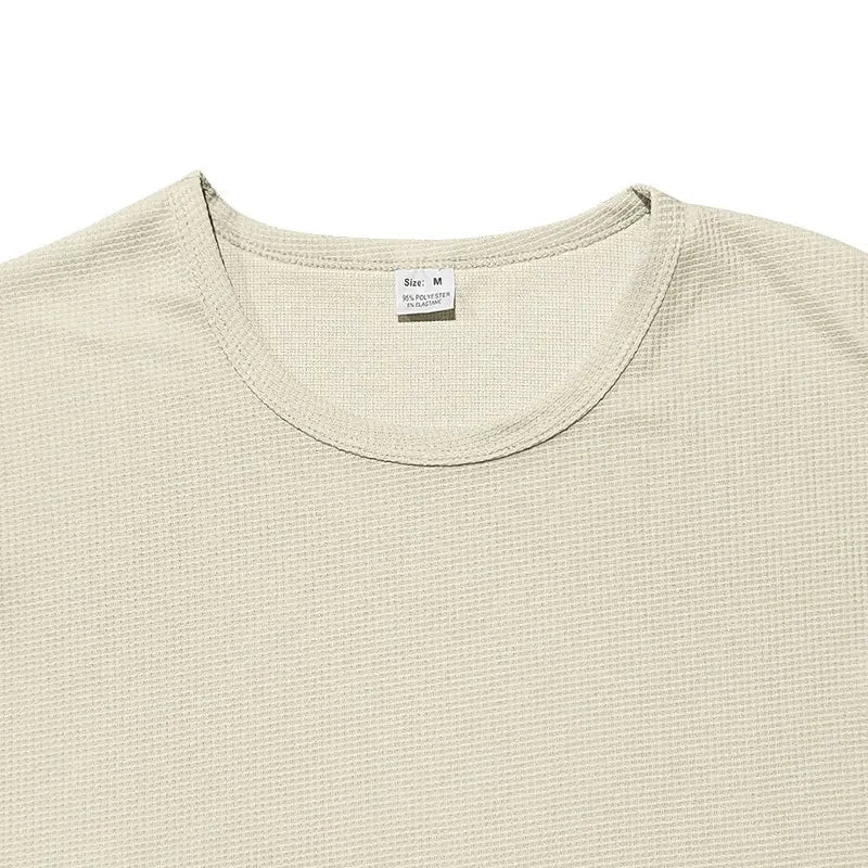 Beige textured knit men’s long sleeve waffle knit thermal pullover with crew neck and size label visible.