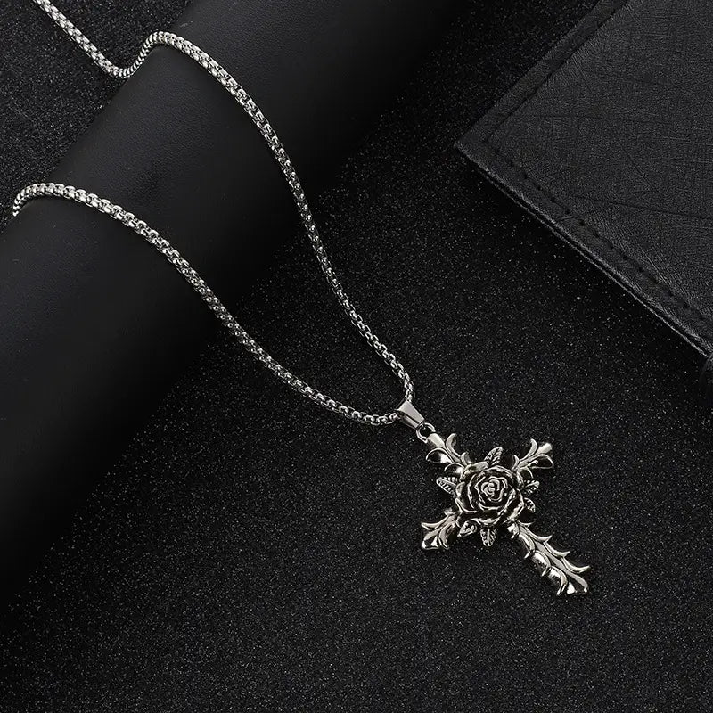 Detailed silver rose cross pendant necklace with a textured silver chain.