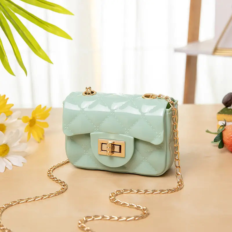 Mint green mini quilted pearl crossbody bag for women featuring a quilted design with a gold-tone chain strap and clasp.