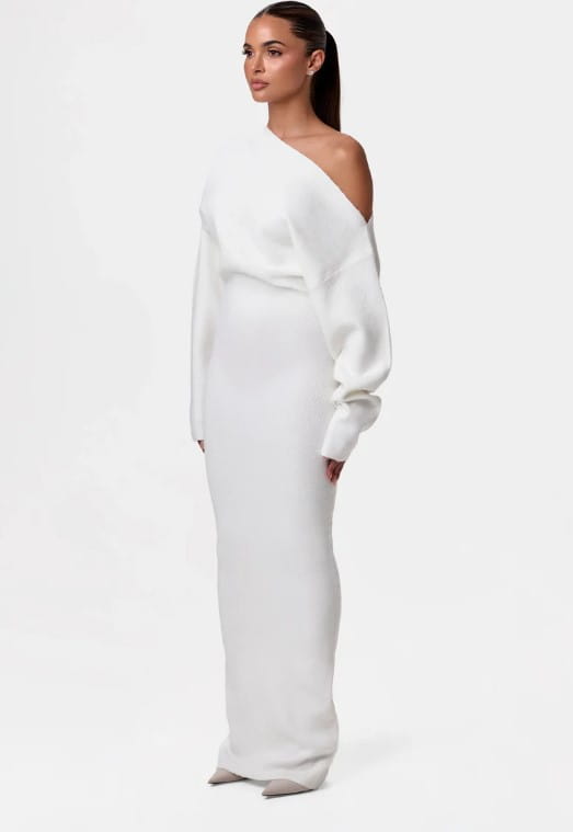 A sleek off shoulder long sleeve knitted bodycon maxi dress in white featuring a one shoulder design with voluminous sleeves and a fitted silhouette.