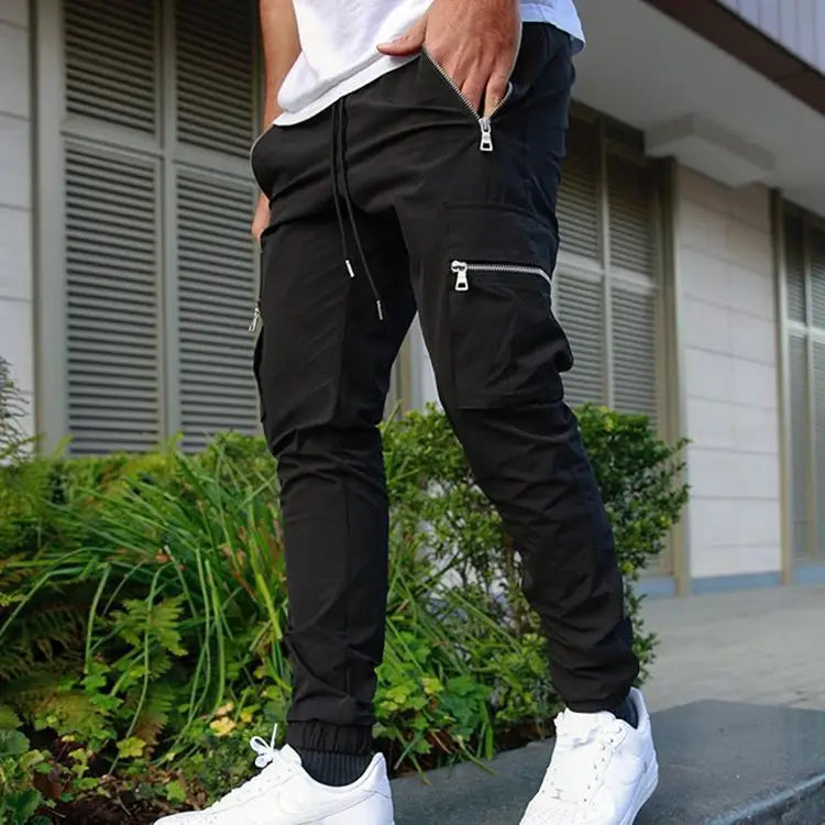 Men’s black zipper cargo joggers casual pants featuring multiple zippered pockets and a drawstring waistband.