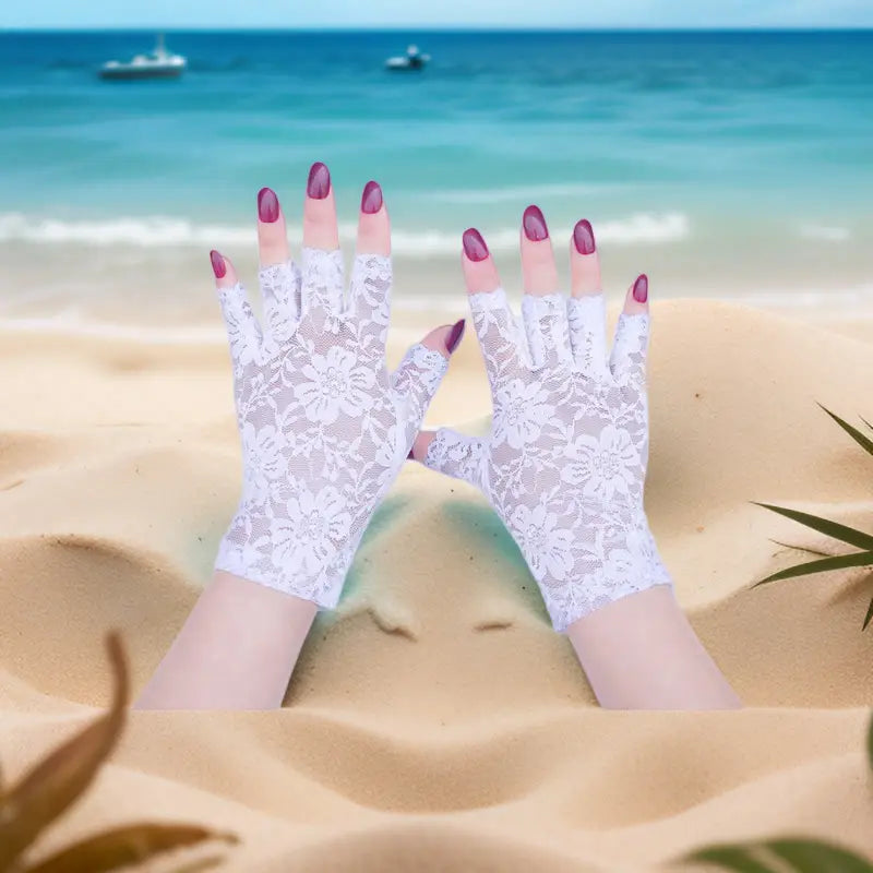 White floral lace fingerless gloves for women featuring a delicate intricate pattern designed for sun protection.