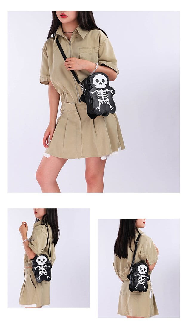 Sac bandoulière de forme croix-de-tête du squelette noir, avec un motif de crâne et d’os blancs, adapté aux accessoires de mode Y2k.