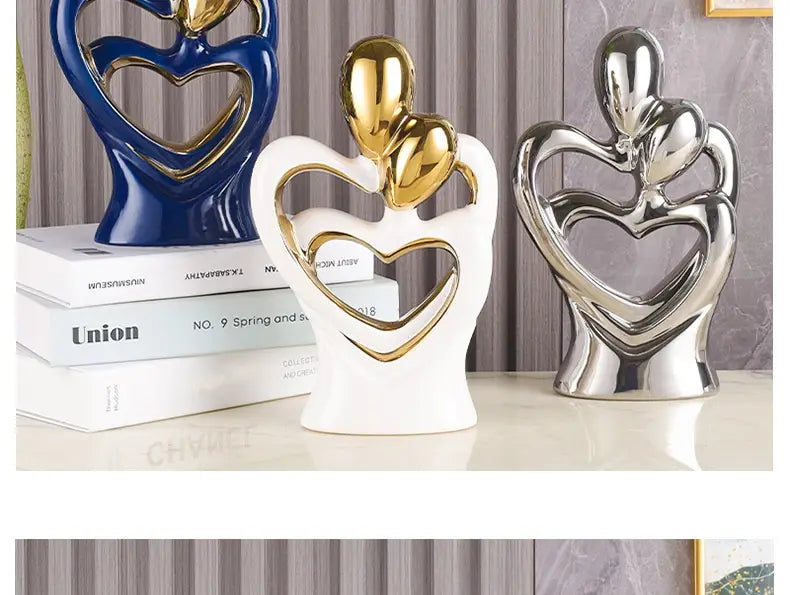 White ceramic abstract heart figurine with gold heart accents and a glossy finish for modern home decor.