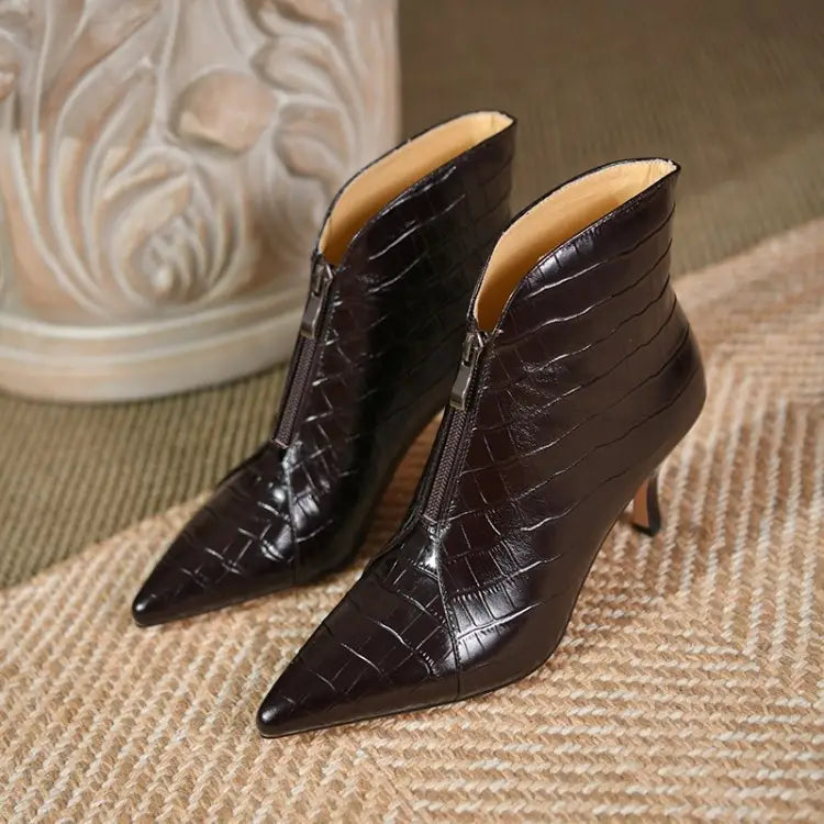 Black crocodile embossed leather ankle boots with a pointed toe and slender stiletto heel.